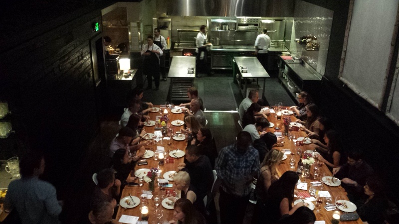 2014-10-29 19.44.49.jpg - View of the two long communal tables and open kitchen of Lazy Bear.  Taken from the loft area of the restaurant, while waiting for the first seating to finish.